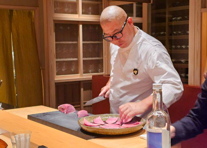 Chef Katayanagi Haruka, painstakingly slicing and selecting cuts of wagyu beef.